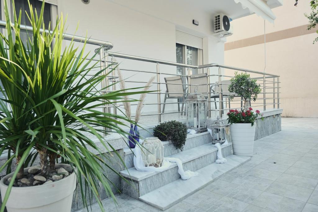 a set of stairs with potted plants on them at BUTTERFLY SUITES by STELIOS in Keramotí