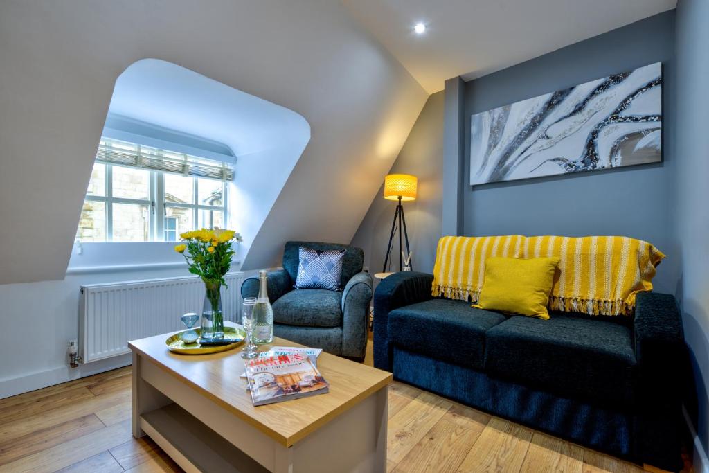 a living room with a couch and a chair at Stamford Central Stay - Stylish 2-Bed Apartment with WiFi in Stamford