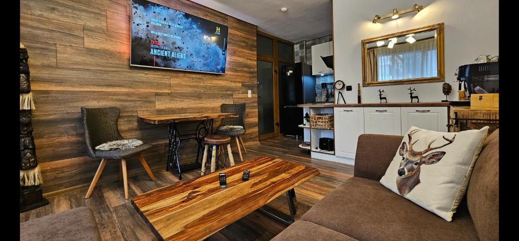 a living room with a couch and a table at Апартамент Bella Casa in Beli Iskar