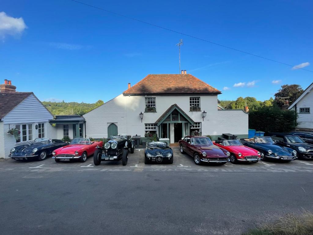 un groupe de voitures garées devant un bâtiment dans l'établissement The Kings Head, à Dorking