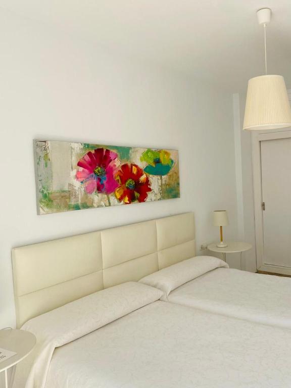 Postel nebo postele na pokoji v ubytování Hostal Tres Soles