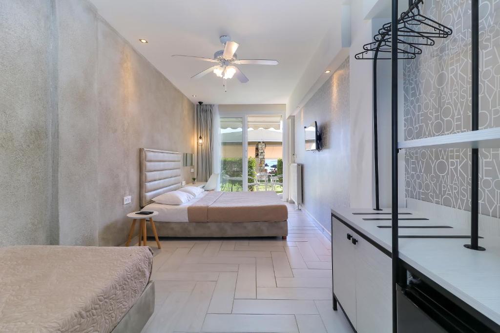 A bed or beds in a room at Porto Palio Beach Hotel