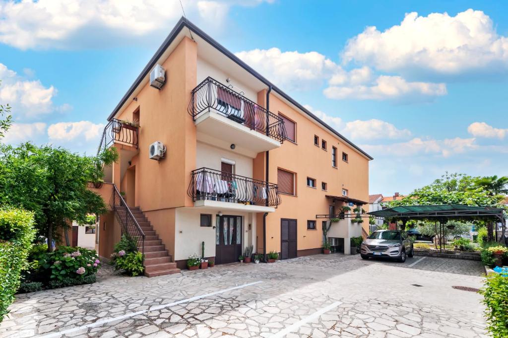 a building with a car parked in front of it at BANKO APARTMENTS & Rooms in Rovinj