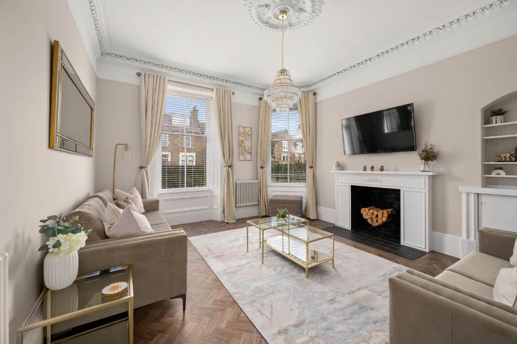 a living room with a couch and a fireplace at Casa Fresa - Taymouth House in Broughty Ferry