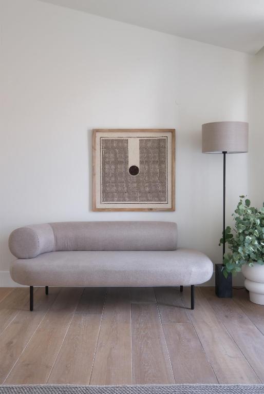 a couch in a living room with a lamp at Villa Sofia Cascais in Cascais