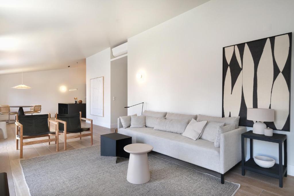 a living room with a couch and a table at Villa Sofia Cascais in Cascais
