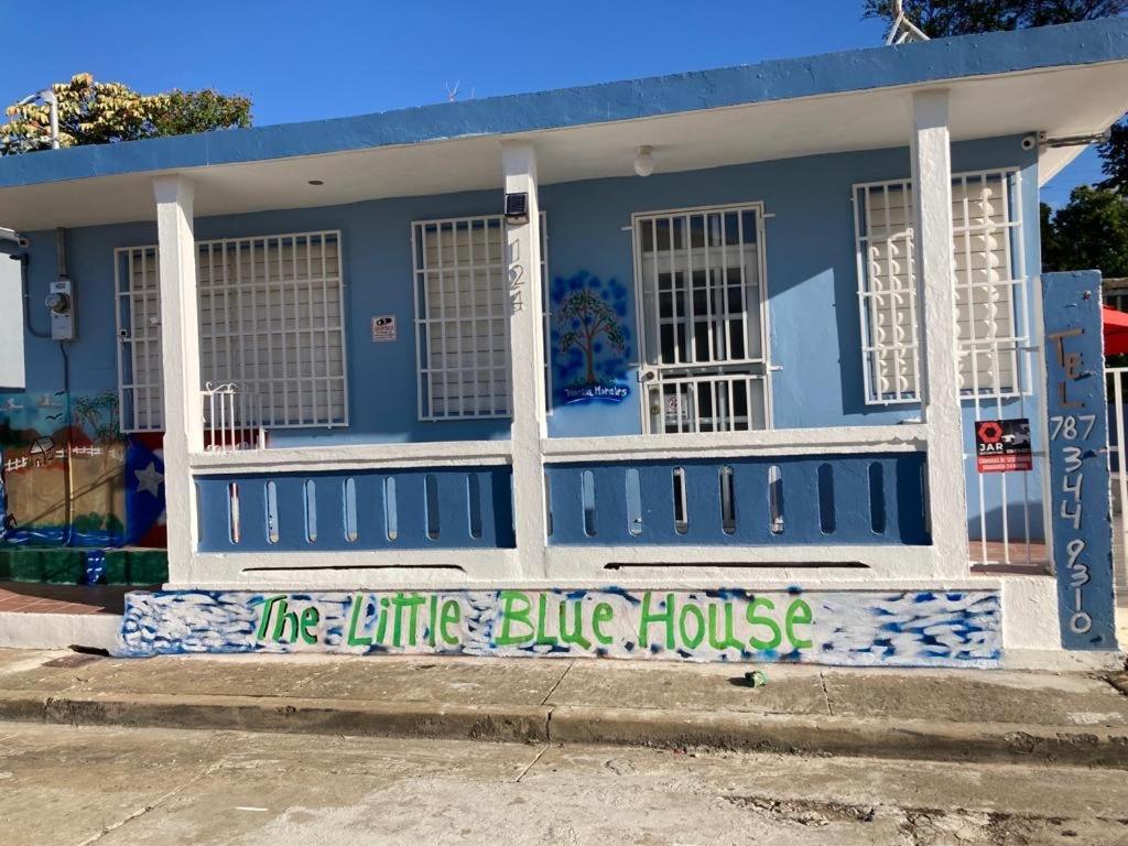 a blue house with graffiti painted on it at The Little Blue House in Guayama