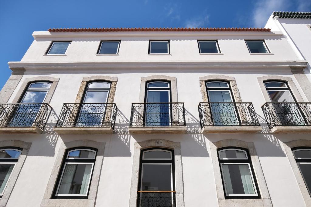 a white building with balconies on it at Villa Sofia Cascais in Cascais