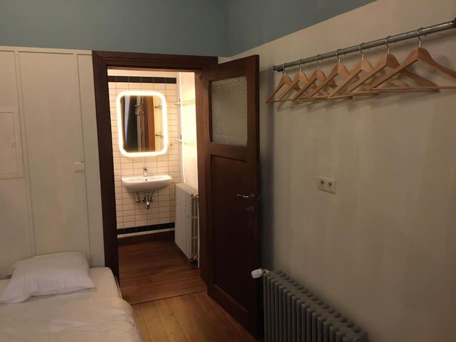 a bathroom with a sink and a bed in a room at ziggy's room with a view in Heyd