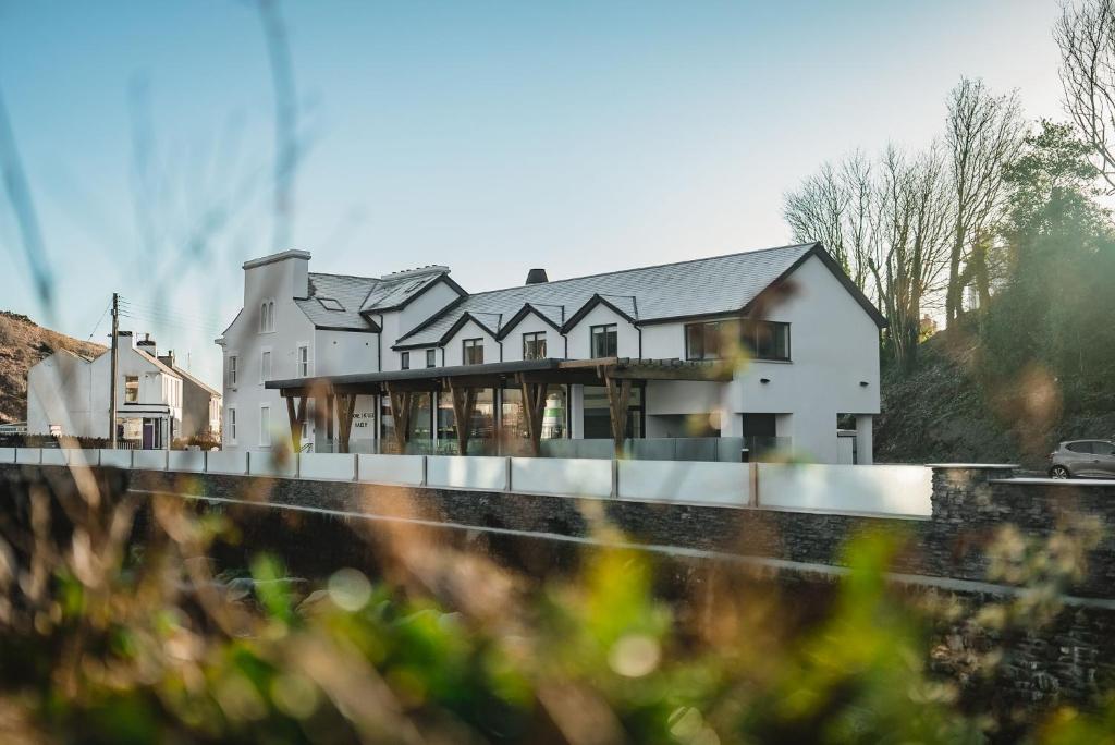 a large white house on the side of a road at Shore Hotel Laxey in Laxey