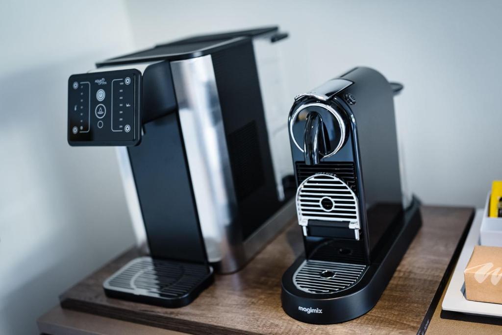 a black coffee maker sitting on a desk at Shore Hotel Laxey in Laxey