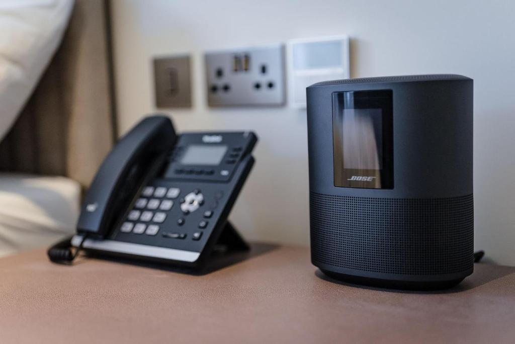 a black phone sitting on a table next to a phone at Shore Hotel Laxey in Laxey