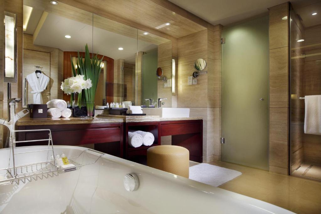 a bathroom with a bath tub and a sink at InterContinental Hangzhou, an IHG Hotel in Hangzhou