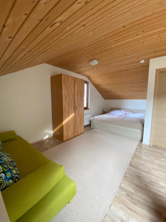 a bedroom with two beds and a wooden ceiling at Apartma Regina in Slovenj Gradec