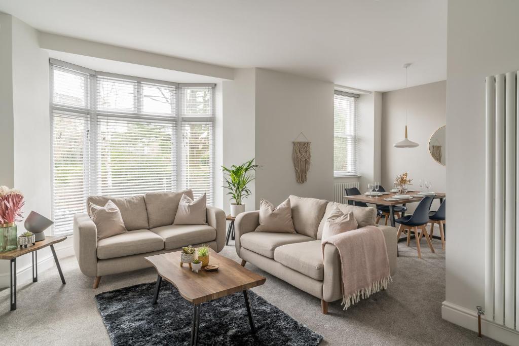 a living room with two couches and a table at Tudor House-Windermere Centre in Windermere