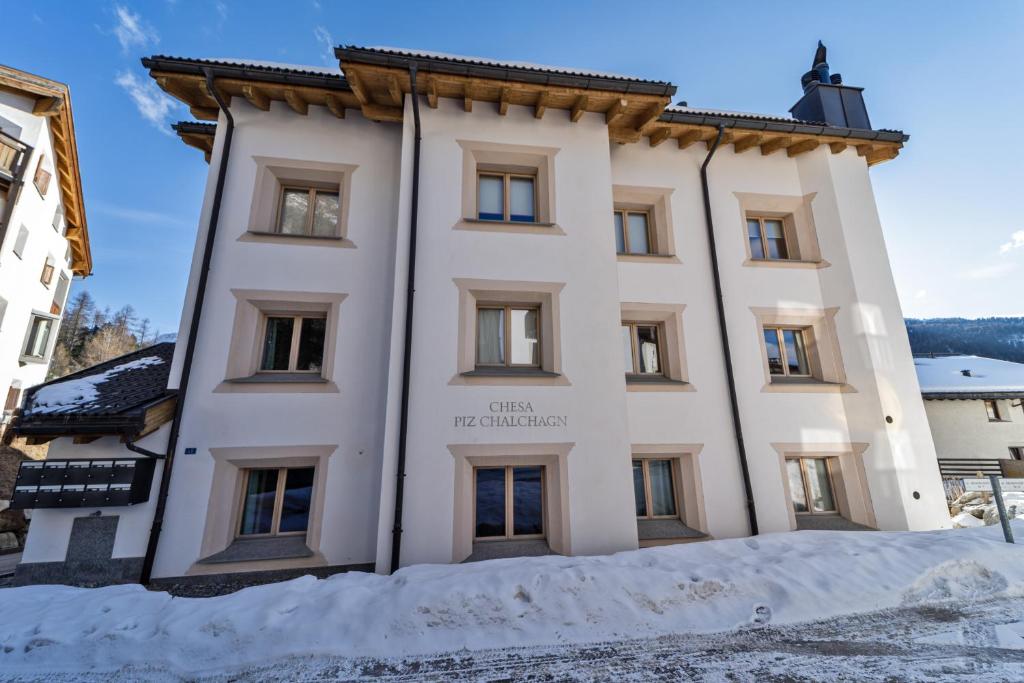 a building with snow in front of it at Chesa Piz Chalchagn - Pontresina in Pontresina