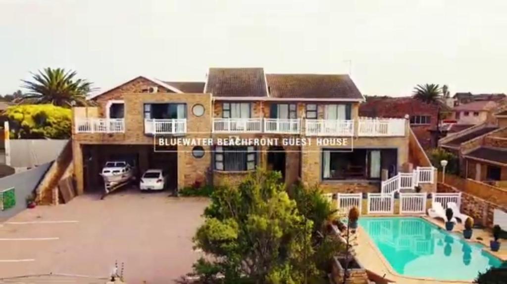 a large house with a swimming pool in front of it at Bluewater Reservations in Port Elizabeth