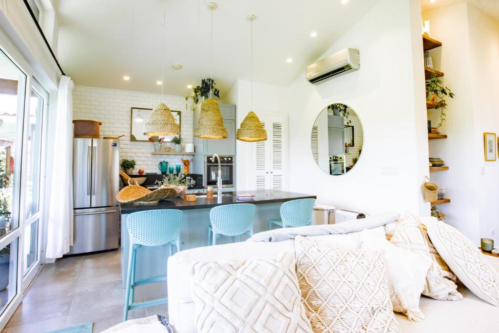 a kitchen with blue chairs and a kitchen island at Villa #17 - Blue Venao, Playa Venao in Playa Venao