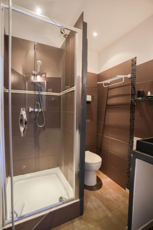 a bathroom with a shower and a toilet at Hostellerie LE PANEL in Mandelieu-La Napoule