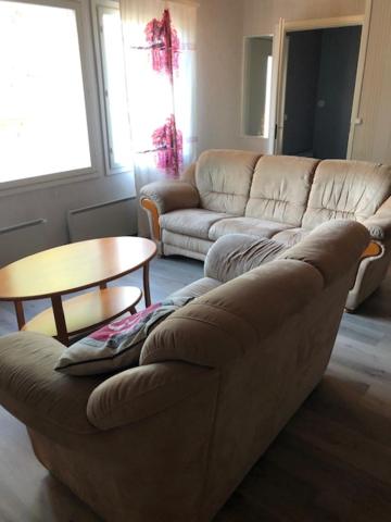 a living room with a couch and a table at Viivin tuvat C in Rantatöysä