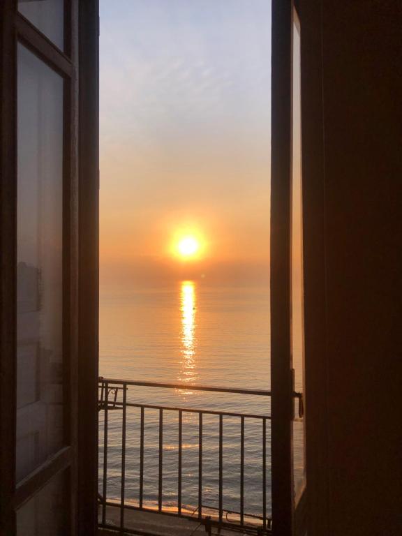a view of a sunset from a window at B&B Vista Mare in Naples
