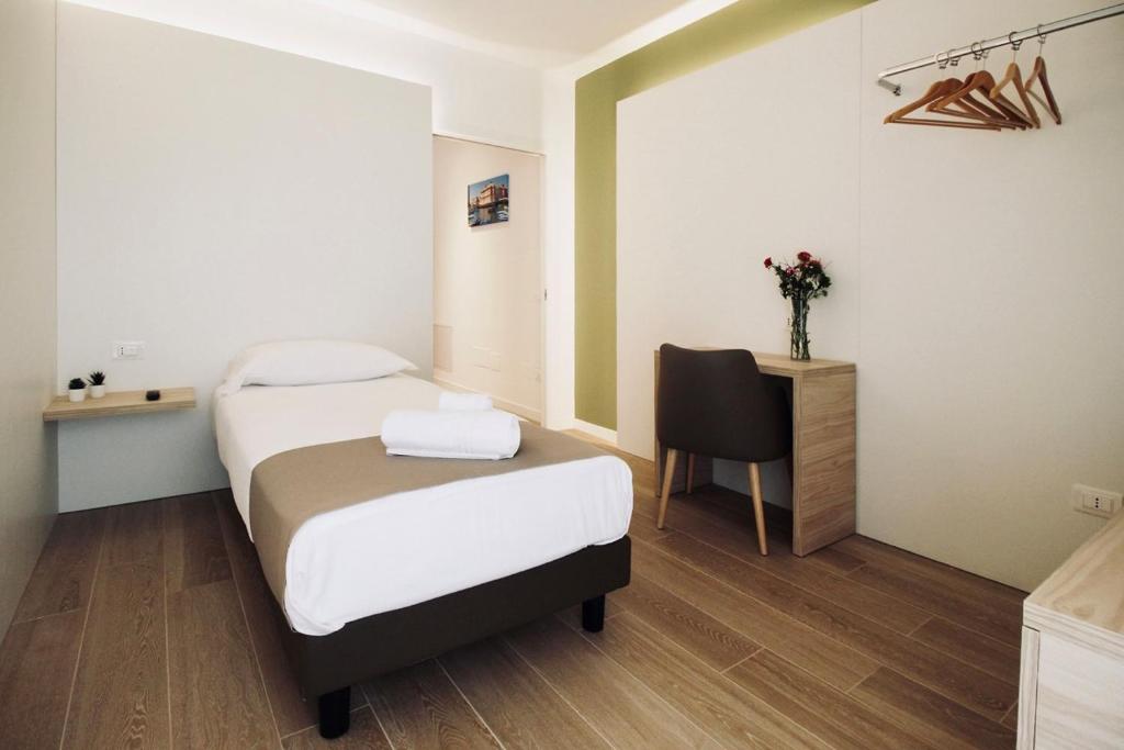 A bed or beds in a room at Hotel Olivò