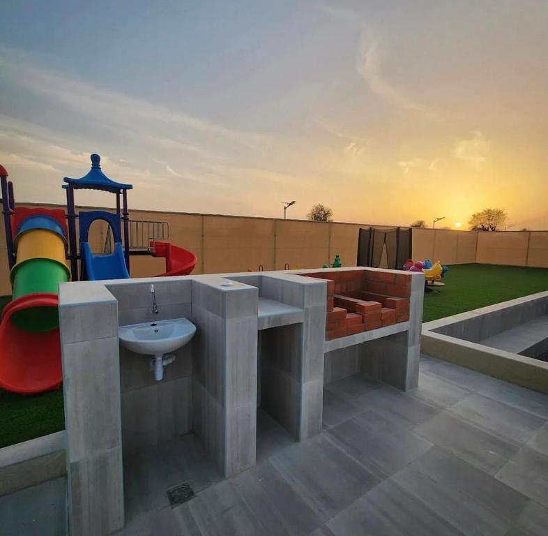 a playground with a sink and a play area at UptownRak FarmHouse in Diqdāqah