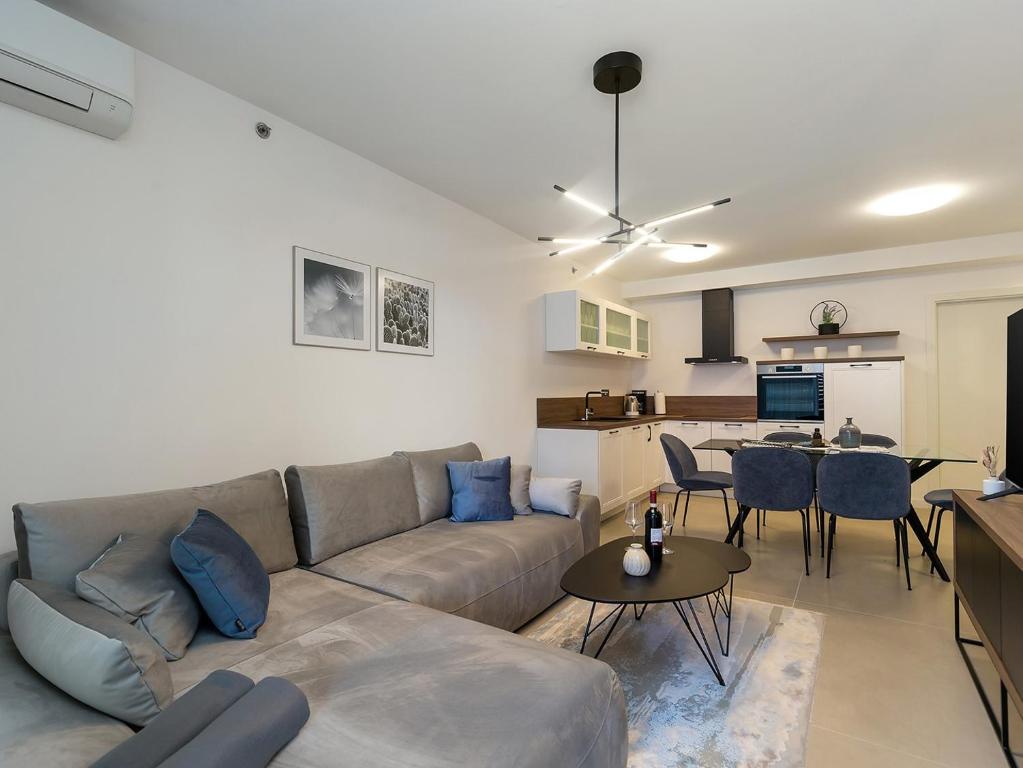 a living room with a couch and a table at Residence Nar in Poreč