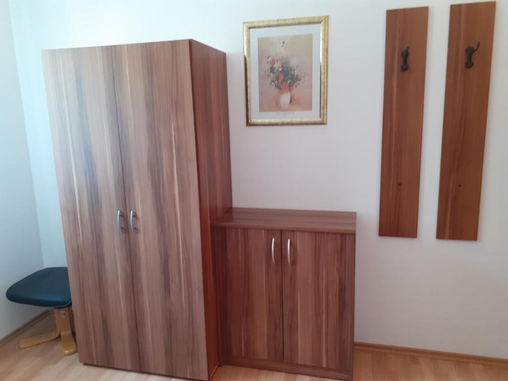 two wooden cabinets in a room with a blue chair at Tisá 488 in Tisá