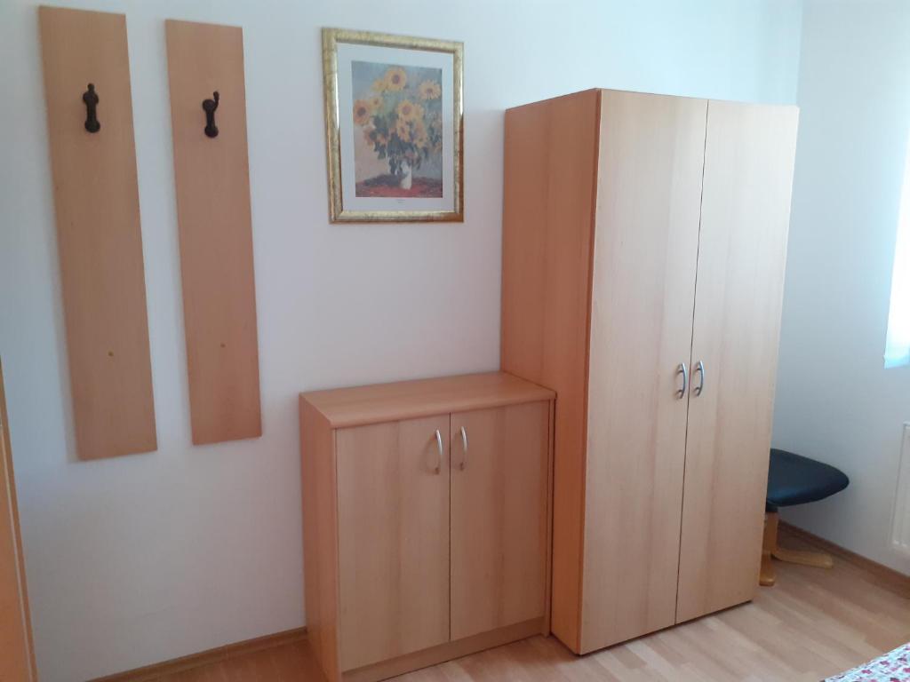 a room with two cupboards and a painting on the wall at Tisá 488 in Tisá