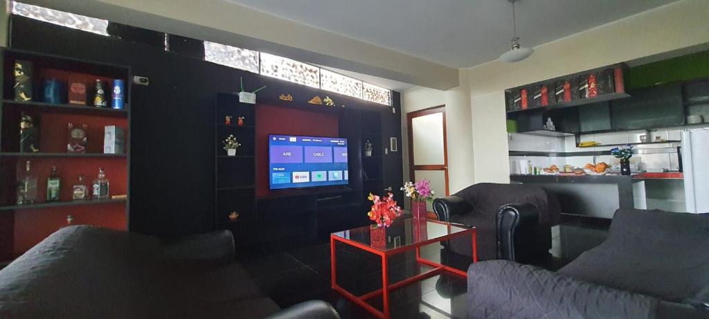 a living room with two couches and a tv at Apartamento Acogedor in Huancayo