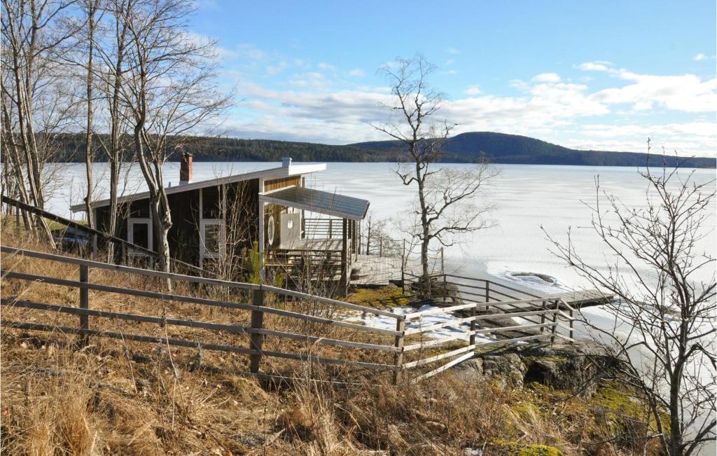 a house on the shore of a body of water at Stunning Home In motfors With Lake View in Åmotsfors