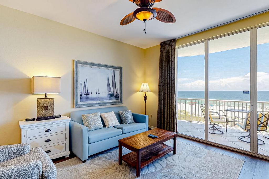 a living room with a couch and a view of the ocean at Spanish Key 304 in Perdido Key