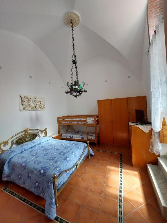 a bedroom with a bed and a chandelier at Casa Muse in Maiori