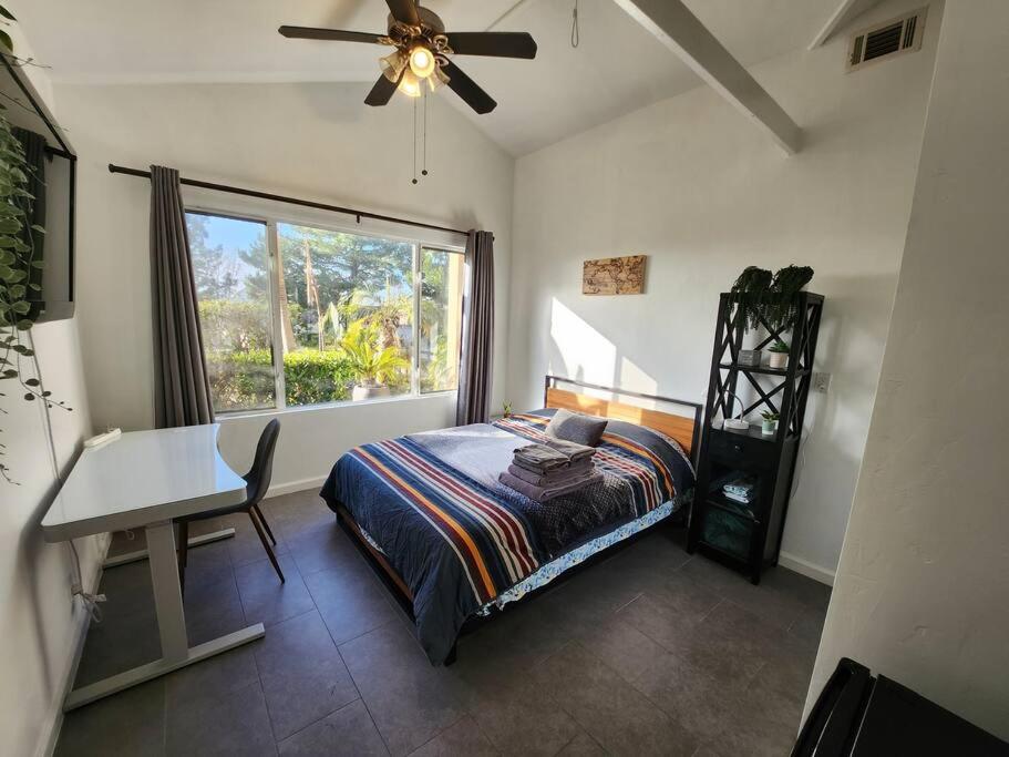 sypialnia z łóżkiem, biurkiem i oknem w obiekcie Guest Quarters Torrey Pines Golf Ucsd Salk Scripps w mieście San Diego