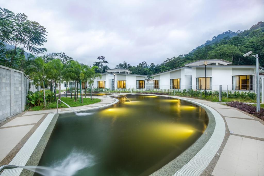a pond in the courtyard of a villa at ēRYA by SURIA Hot Spring Bentong in Bentong