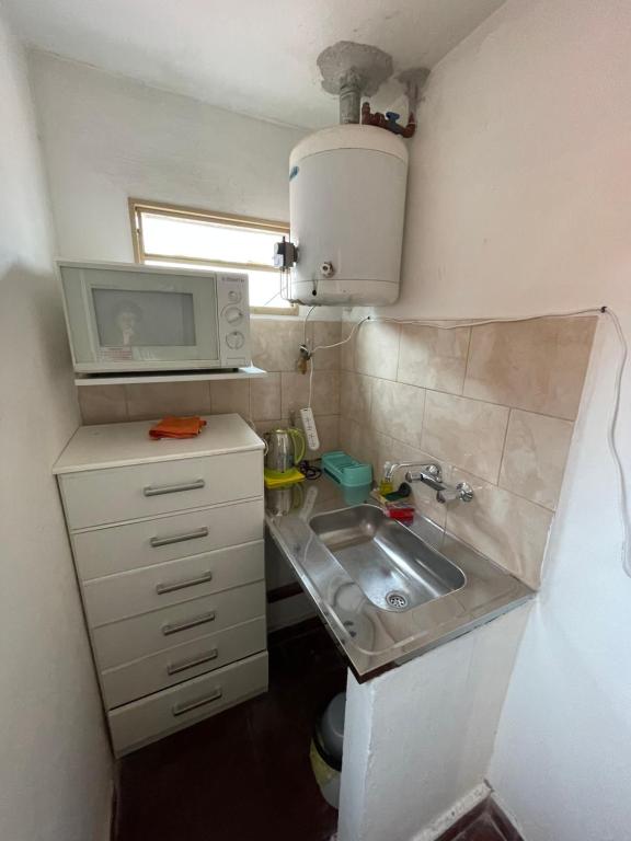 a small kitchen with a sink and a microwave at Departamento zona centro , Catamarca in San Fernando del Valle de Catamarca