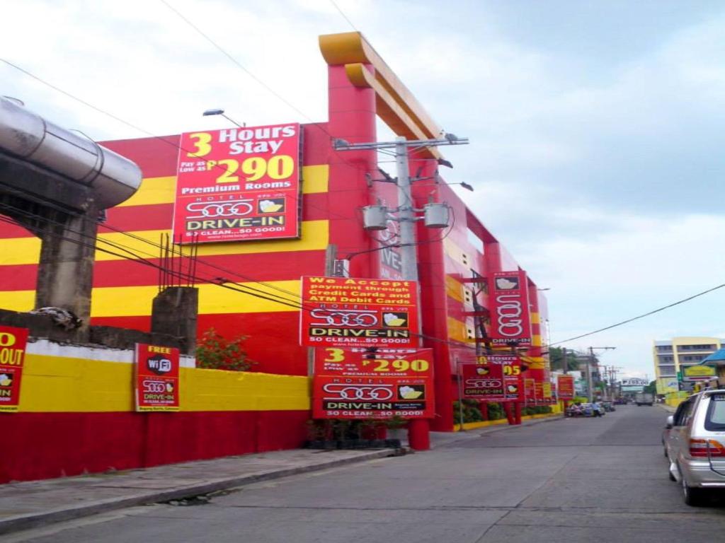 a building with signs on the side of a street at Hotel Sogo - Bagong Barrio, Caloocan in Manila
