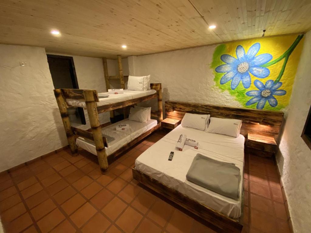 a room with two beds and a painting on the wall at Prana in San Gil