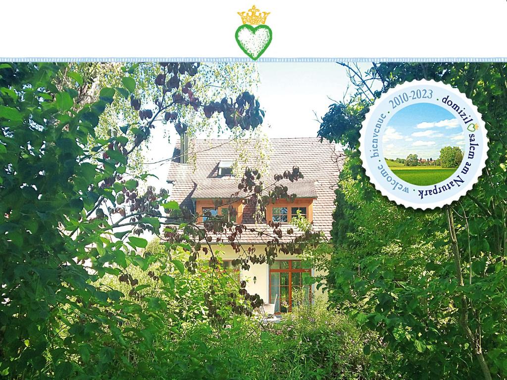 una foto di una casa con specchio e alberi di Domizil Salem "Large" 105 qm, direkt am Naturschutzgebiet und Schloss Salem, 2 x Schlafzimmer & 2 x Dusche & 30 qm Terrasse & privater Garten 300 qm, Allergiker geeignet a Salem