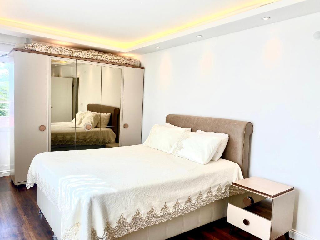 a bedroom with a bed and a mirror at Airport Villa hotel in Arnavutköy