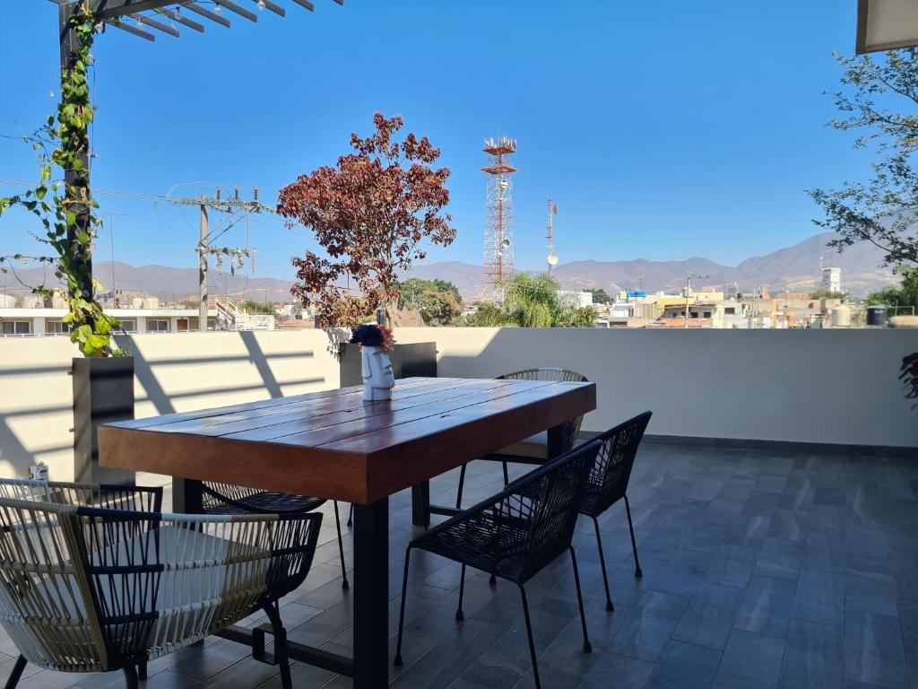 a wooden table and chairs on a patio at Casa Moreno Deluxe in Ameca