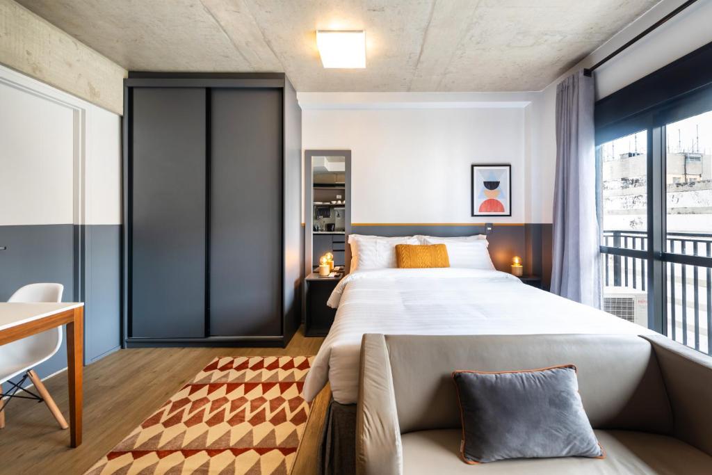 1 dormitorio con 1 cama grande y balcón en 91 Design studio near Paulista, en São Paulo