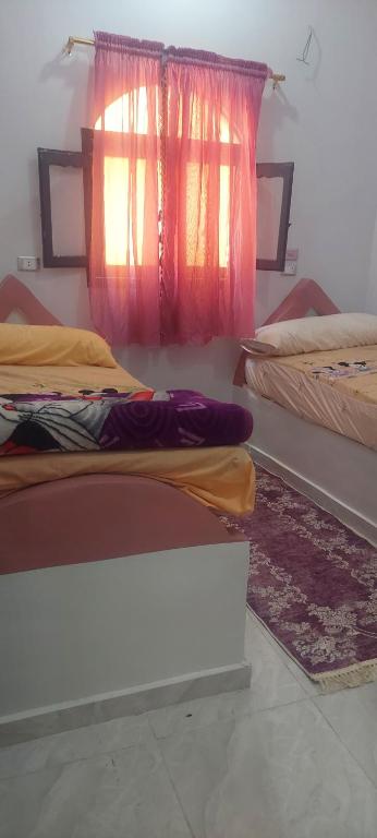 Postel nebo postele na pokoji v ubytování Abo Tamem Guest House