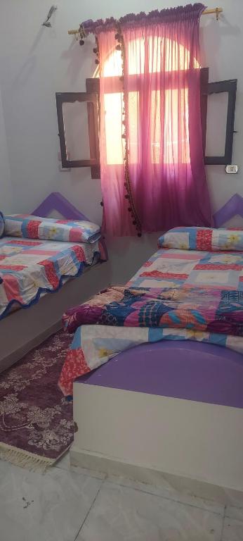 Postel nebo postele na pokoji v ubytování Abo Tamem Guest House