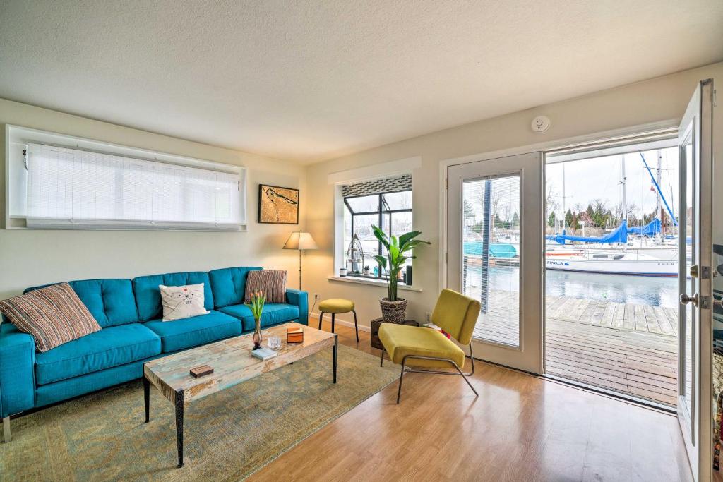 a living room with a blue couch and a table at Portland Floating Home Getaway with Sauna! in Portland