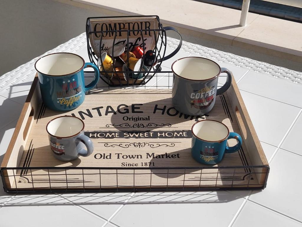 a tray with three coffee mugs on a table at Casa al Mare in Bari