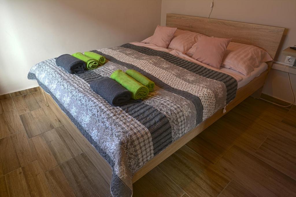 a bed with two pillows on top of it at Demetrovics Udvarház in Eger
