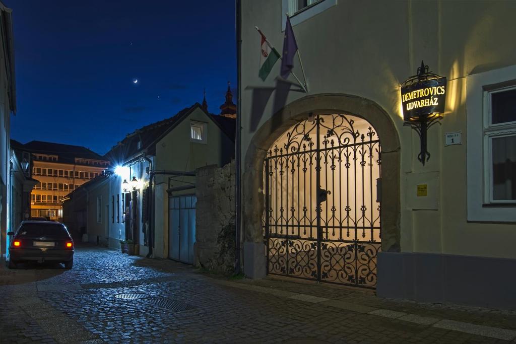 a gate to a building with a sign on it at Demetrovics Udvarház in Eger