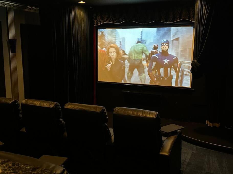 a cinema room with a large screen with a movie at The perfect Gulfport Fl Getaway! in St Petersburg